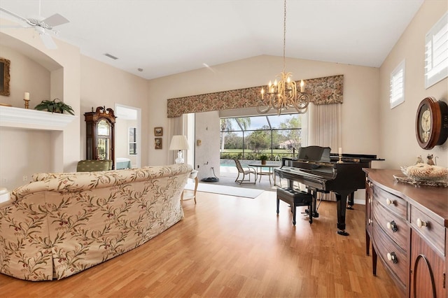 living area featuring visible vents, vaulted ceiling, and light wood-style flooring