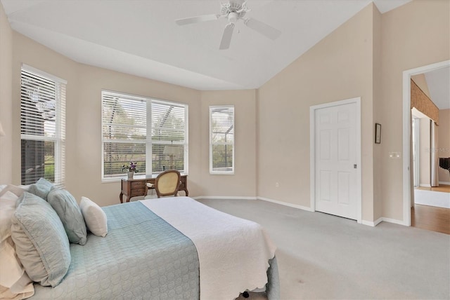 carpeted bedroom with lofted ceiling, ceiling fan, and baseboards