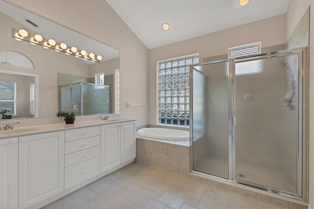 bathroom with a stall shower, a sink, a bath, and a healthy amount of sunlight