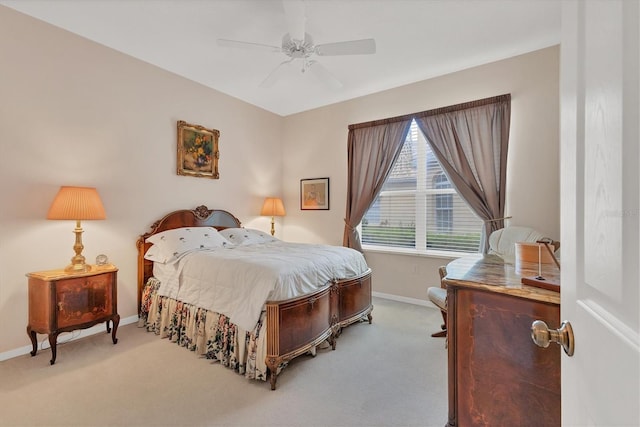 bedroom featuring baseboards, ceiling fan, and light colored carpet