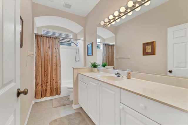 full bathroom featuring toilet, shower / bath combo, vanity, and visible vents