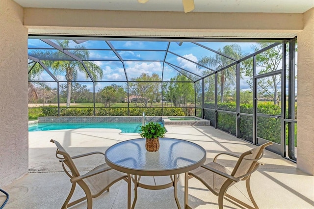 view of patio / terrace featuring a lanai and a pool with connected hot tub