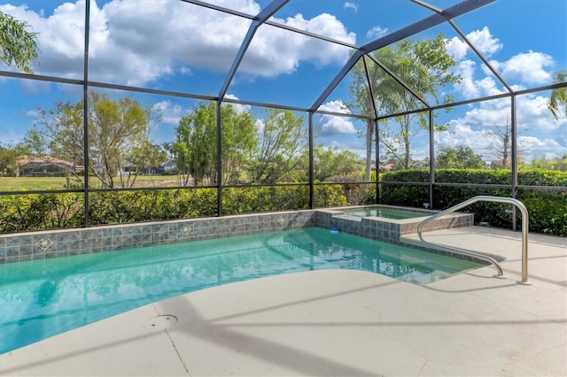 view of swimming pool with glass enclosure, a pool with connected hot tub, and a patio area