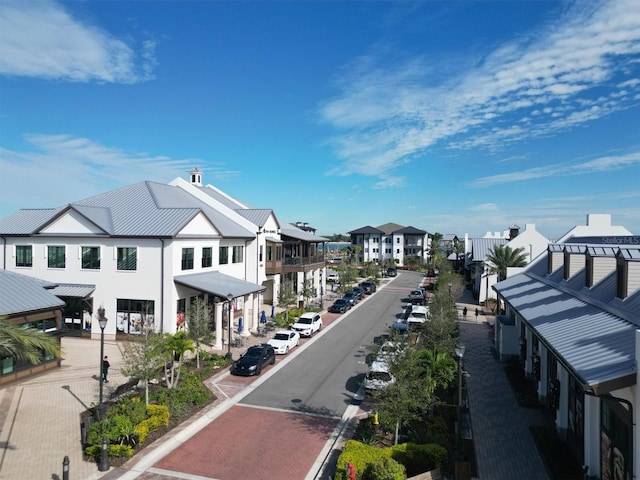 view of road featuring a residential view and curbs