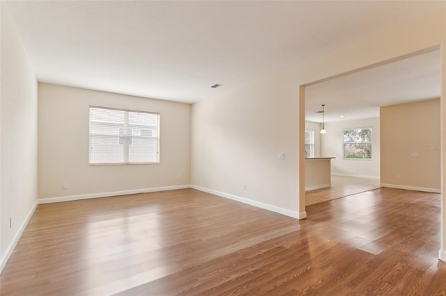 spare room with light wood finished floors and baseboards