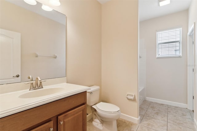 bathroom with tile patterned flooring, baseboards, vanity, and toilet