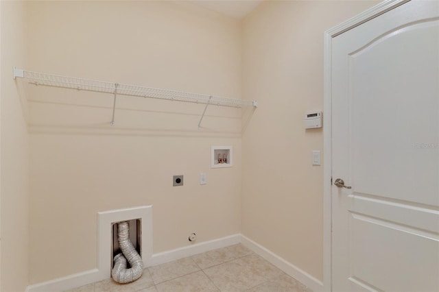 laundry area with light tile patterned floors, hookup for a washing machine, hookup for an electric dryer, laundry area, and baseboards