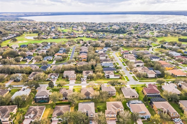 drone / aerial view featuring a residential view and a water view