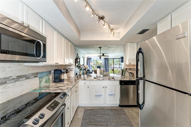 kitchen with white cabinetry, visible vents, and appliances with stainless steel finishes