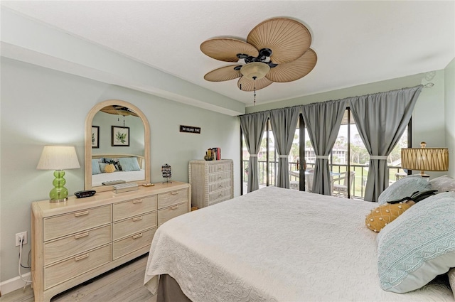 bedroom featuring light wood-type flooring, ceiling fan, and baseboards