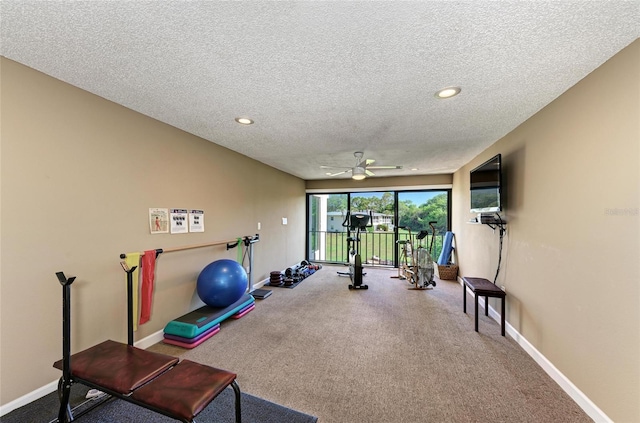 exercise room with a textured ceiling, recessed lighting, and baseboards