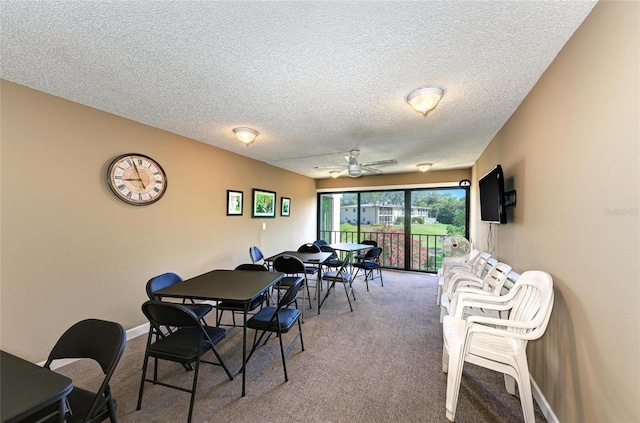 dining space featuring carpet floors, ceiling fan, baseboards, and a textured ceiling