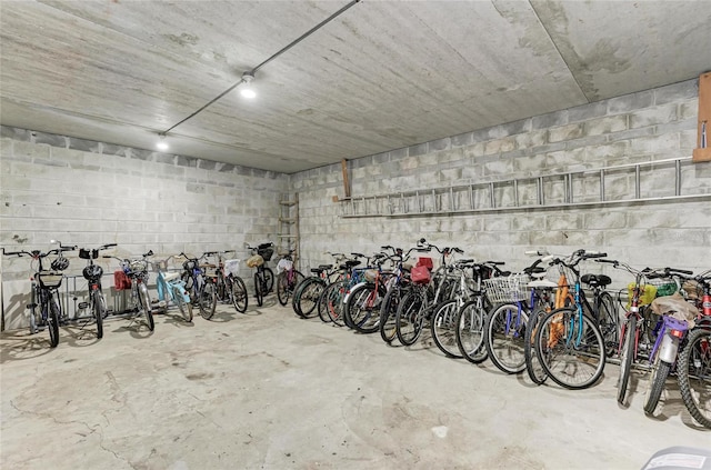 garage featuring concrete block wall and bike storage