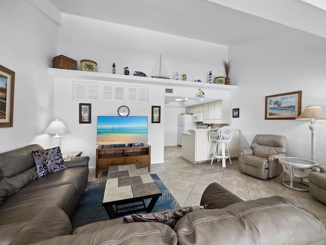 4621 Gulf Of Mexico Dr Unit 19B, Longboat Key, FL 34228 - living room featuring a towering ceiling and light tile patterned flooring