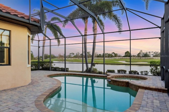 view of swimming pool with a lanai, a water view, a pool with connected hot tub, and a patio