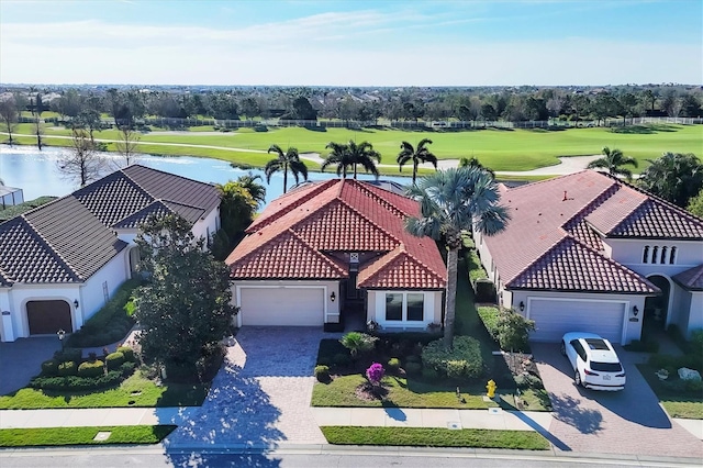 birds eye view of property with a water view and golf course view