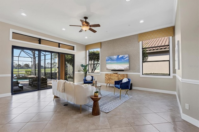 living area with recessed lighting, ceiling fan, baseboards, and ornamental molding