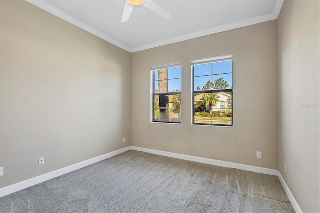 spare room featuring ornamental molding, carpet flooring, baseboards, and a ceiling fan