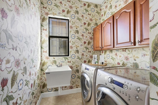 washroom with wallpapered walls, cabinet space, baseboards, washer and clothes dryer, and light tile patterned flooring