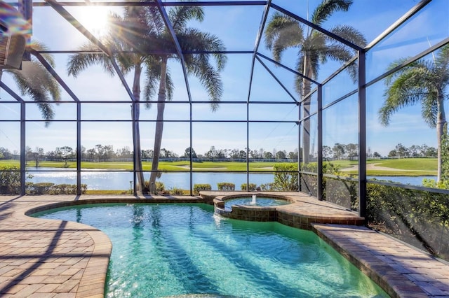 view of pool with a lanai, a water view, and a pool with connected hot tub