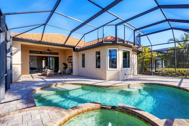 view of pool featuring a patio, a lanai, a pool with connected hot tub, and a ceiling fan