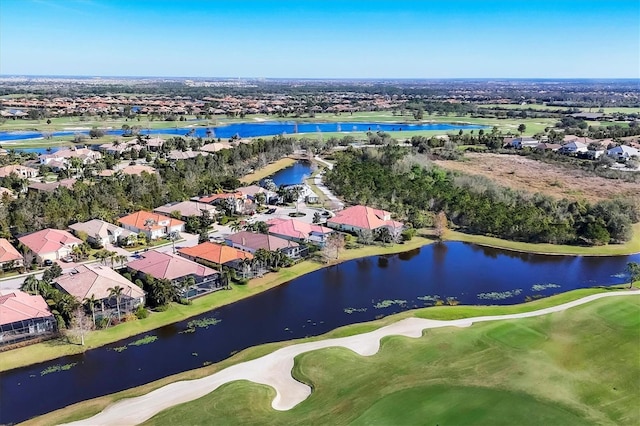 aerial view with view of golf course, a water view, and a residential view