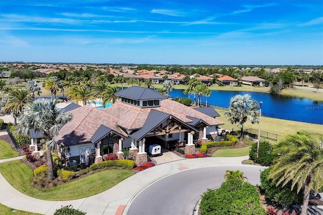 drone / aerial view with a residential view and a water view