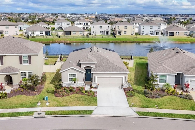 view of front of house featuring concrete driveway, a water view, and a residential view