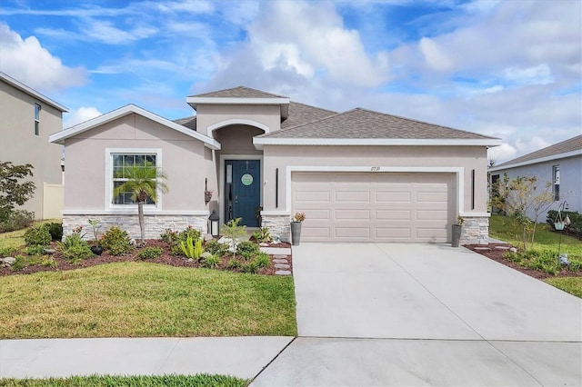 ranch-style house with a garage, stone siding, driveway, stucco siding, and a front yard