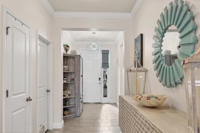 mudroom featuring a notable chandelier, ornamental molding, and wood tiled floor