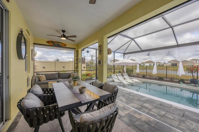 sunroom featuring ceiling fan