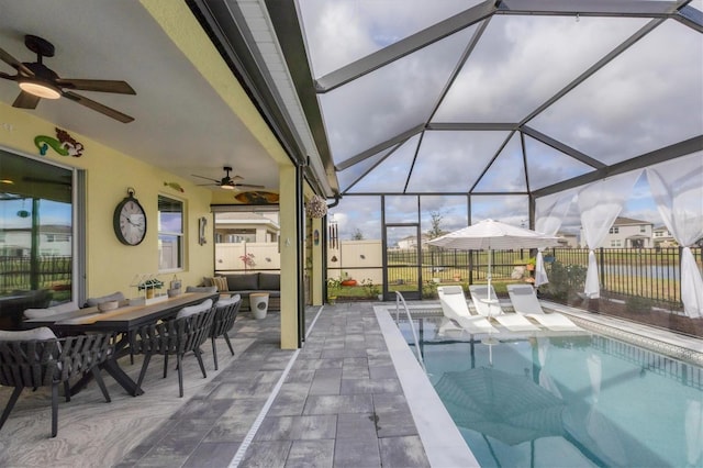 view of swimming pool with a fenced in pool, ceiling fan, a lanai, fence, and a patio area