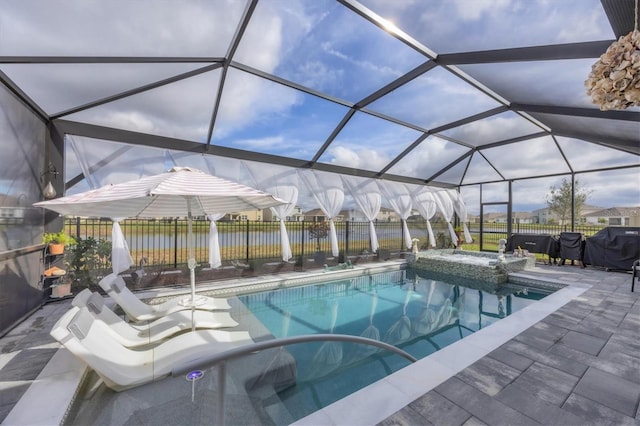 view of swimming pool with a patio, a lanai, a water view, fence, and a pool with connected hot tub