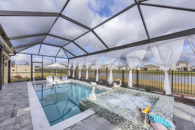 view of pool featuring glass enclosure, a water view, a patio, and a fenced backyard