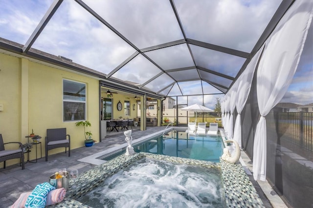 view of swimming pool featuring a lanai, a pool with connected hot tub, fence, and a patio