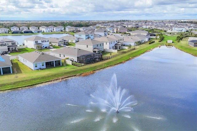 birds eye view of property featuring a water view and a residential view