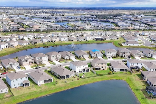 drone / aerial view with a water view and a residential view