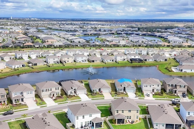 bird's eye view featuring a water view and a residential view