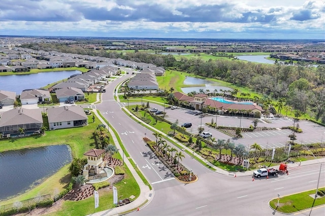 birds eye view of property featuring a water view and a residential view