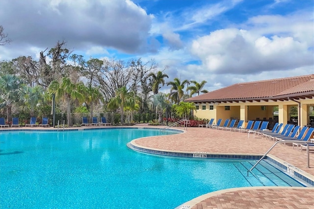 pool featuring fence and a patio