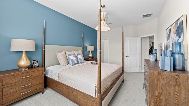 bedroom featuring visible vents and light colored carpet