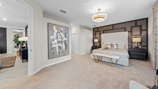 bedroom featuring light colored carpet, a closet, visible vents, and baseboards