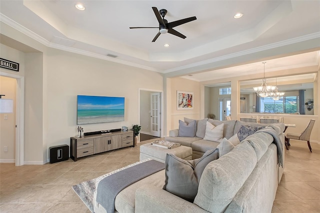 living area featuring ceiling fan with notable chandelier, a raised ceiling, visible vents, and recessed lighting