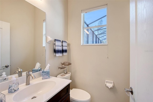 bathroom with toilet and vanity