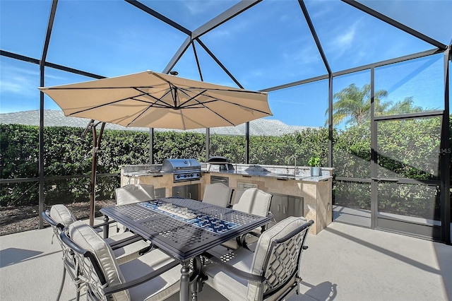 view of patio featuring grilling area, an outdoor kitchen, and a sink