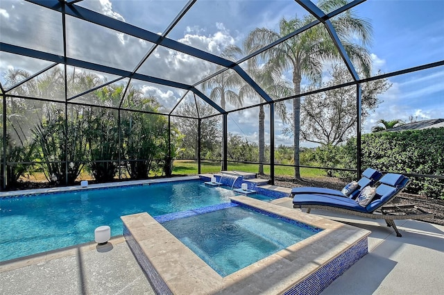 view of swimming pool with a pool with connected hot tub, glass enclosure, and a patio