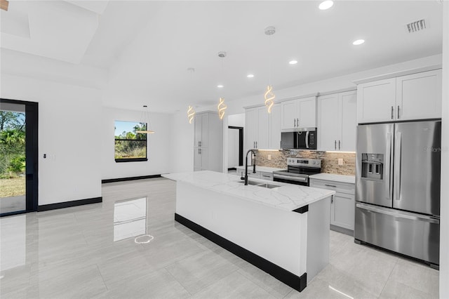 kitchen with pendant lighting, stainless steel appliances, a center island with sink, and white cabinetry