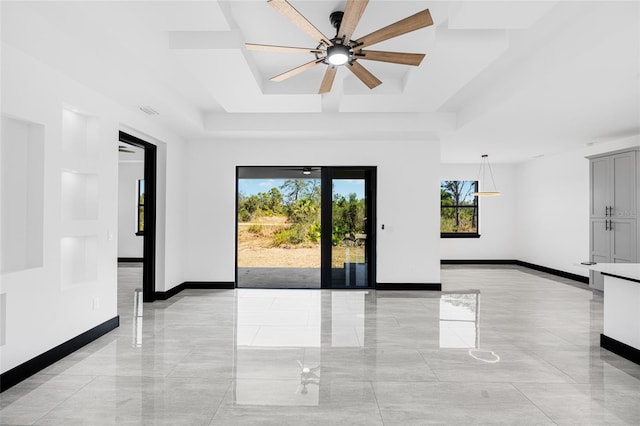 unfurnished room with marble finish floor, baseboards, a raised ceiling, and a ceiling fan