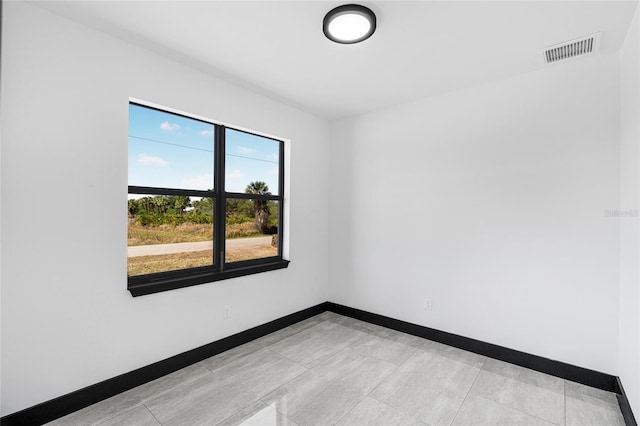 empty room featuring visible vents and baseboards