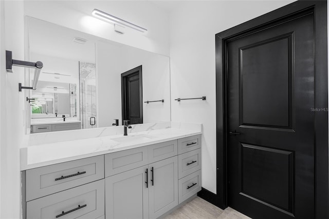 bathroom featuring a stall shower and vanity